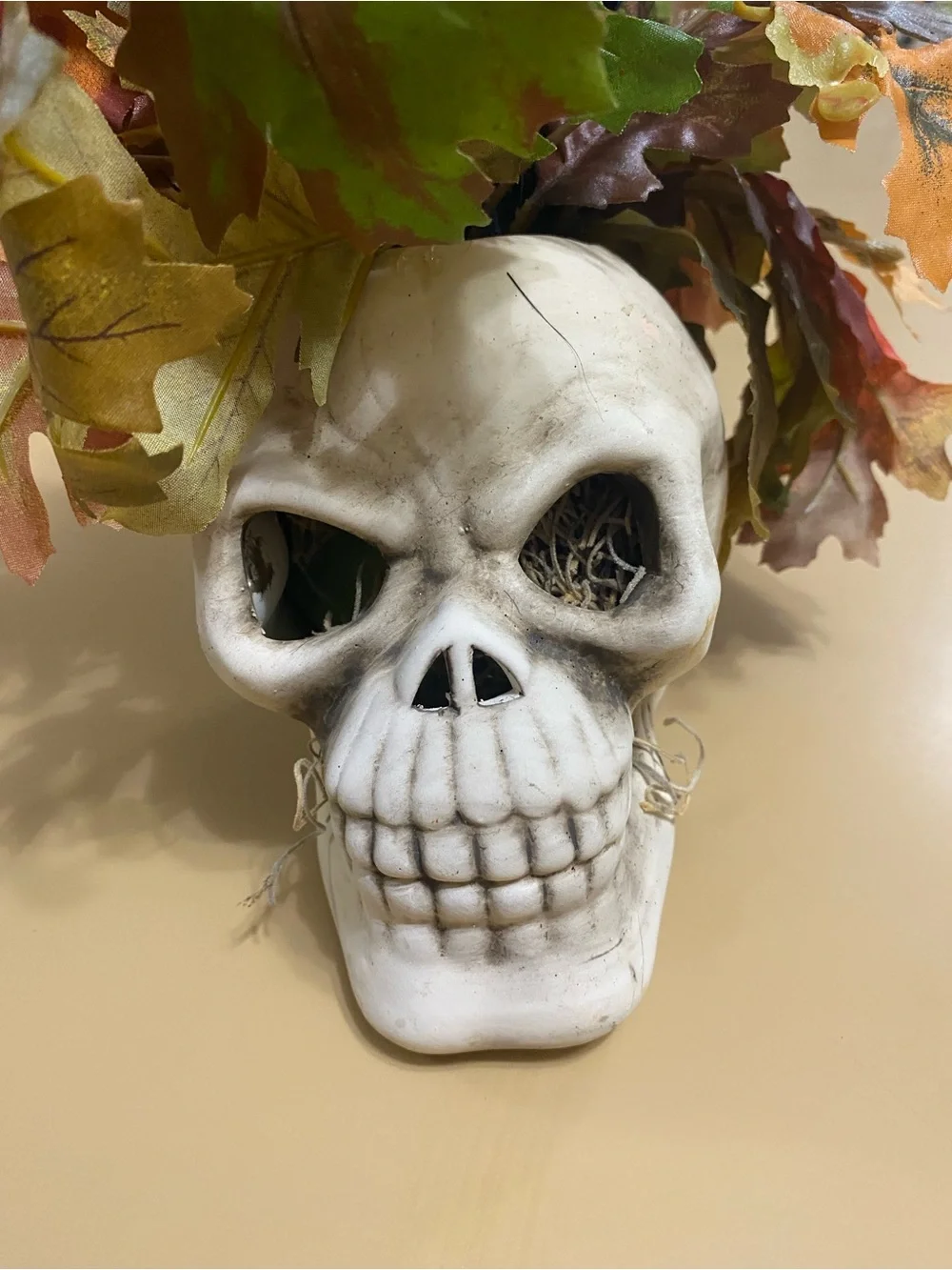 White Skull Vase with Autumn Leaf Faux Floral Arrangement